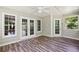Bright sunroom features wood flooring, fan, and multiple windows providing lots of light at 3925 Waterford Dr, Suwanee, GA 30024