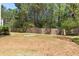 An expansive backyard with lush green lawn and a wood privacy fence at 4013 Suwanee Place Dr, Suwanee, GA 30024