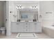 Bright bathroom featuring a double vanity, a tub, and modern finishes at 4013 Suwanee Place Dr, Suwanee, GA 30024