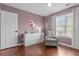 This bedroom is painted a soft color with modern furnishings at 4013 Suwanee Place Dr, Suwanee, GA 30024