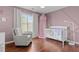 This Bedroom is decorated with a soft color palette and hardwood floors at 4013 Suwanee Place Dr, Suwanee, GA 30024