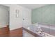 Bedroom with decorative accent wall, hardwood floors, and natural light at 4013 Suwanee Place Dr, Suwanee, GA 30024