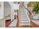Bright foyer with hardwood floors, staircase, and views into the formal living room, creating an inviting entrance at 4013 Suwanee Place Dr, Suwanee, GA 30024