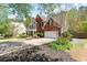 Stately two-story home with brick and siding, manicured lawn, and mature landscaping at 4013 Suwanee Place Dr, Suwanee, GA 30024