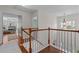 Hallway with hardwood floors, natural light, and a view into the main bedroom at 4013 Suwanee Place Dr, Suwanee, GA 30024