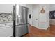 Kitchen with stainless steel refrigerator, mosaic backsplash, hardwood floors, and decorative wall decor at 4013 Suwanee Place Dr, Suwanee, GA 30024
