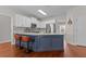 Contemporary kitchen with white cabinetry, stainless steel appliances, and a stylish island with seating at 4013 Suwanee Place Dr, Suwanee, GA 30024
