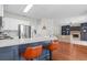 Modern kitchen features white cabinets, stainless steel appliances, and an island with bar stool seating at 4013 Suwanee Place Dr, Suwanee, GA 30024