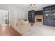 Cozy living room features a stone fireplace, custom blue built-ins, and comfortable beige sectional sofa at 4013 Suwanee Place Dr, Suwanee, GA 30024