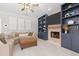 Stylish living room showcases custom shelving, a stone fireplace, and a comfortable sectional for relaxing at 4013 Suwanee Place Dr, Suwanee, GA 30024