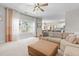 Bright living room featuring large windows, light curtains, and an open layout leading into the kitchen at 4013 Suwanee Place Dr, Suwanee, GA 30024
