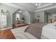 Spacious main bedroom with a dedicated office area, hardwood floors, and tray ceilings at 4013 Suwanee Place Dr, Suwanee, GA 30024