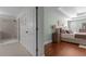 This main bedroom boasts wood floors and a bathroom with tile floors and a glass shower at 4013 Suwanee Place Dr, Suwanee, GA 30024