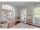 Cozy playroom with arched entrance, large windows, hardwood floors, and a bright, inviting atmosphere at 4013 Suwanee Place Dr, Suwanee, GA 30024