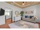 Stylish sitting area with elegant decor, a comfortable sofa, and views into the kitchen, perfect for relaxing at 4013 Suwanee Place Dr, Suwanee, GA 30024
