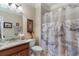 Bathroom with a granite countertop vanity, tile flooring, a shower/tub, and a decorative shower curtain at 4538 Sterling Pointe Nw Dr, Kennesaw, GA 30152