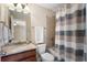 Bathroom featuring a shower-tub combination and a vanity with granite countertops and a decorative mirror at 4538 Sterling Pointe Nw Dr, Kennesaw, GA 30152