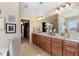 Bright bathroom featuring granite countertops, double sinks, and large mirrors at 4538 Sterling Pointe Nw Dr, Kennesaw, GA 30152