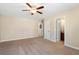 Large bedroom with neutral walls, carpet, ceiling fan, and doorways leading to a bathroom and closet at 4538 Sterling Pointe Nw Dr, Kennesaw, GA 30152