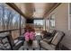 Comfortable covered porch with brick fireplace, TV, and wooded views at 4538 Sterling Pointe Nw Dr, Kennesaw, GA 30152