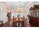 Formal dining room boasts an elegant chandelier, wainscoting, and hardwood floors at 4538 Sterling Pointe Nw Dr, Kennesaw, GA 30152