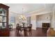 Formal dining room features dark hardwood floors, wainscoting, and an elegant chandelier at 4538 Sterling Pointe Nw Dr, Kennesaw, GA 30152