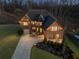 Charming brick home illuminated at twilight, showcasing its well-manicured lawn and inviting facade at 4538 Sterling Pointe Nw Dr, Kennesaw, GA 30152