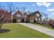 Charming two-story brick home with a well-maintained lawn, elegant landscaping, and attached garage at 4538 Sterling Pointe Nw Dr, Kennesaw, GA 30152