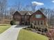 Beautiful brick home with two-car garage, complemented by lush landscaping and an inviting walkway at 4538 Sterling Pointe Nw Dr, Kennesaw, GA 30152