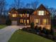 Charming brick home with well-manicured landscaping and a welcoming entrance illuminated at twilight at 4538 Sterling Pointe Nw Dr, Kennesaw, GA 30152