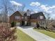 Charming brick home with a two-car garage, long driveway, and meticulously kept lawn at 4538 Sterling Pointe Nw Dr, Kennesaw, GA 30152