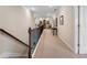 Upstairs hallway with a carpeted floor and wood railing leading to various rooms in the home at 4538 Sterling Pointe Nw Dr, Kennesaw, GA 30152