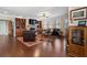 Cozy living room featuring a stone fireplace, built-in bookshelves, and large windows at 4538 Sterling Pointe Nw Dr, Kennesaw, GA 30152