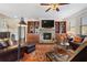 Inviting living room featuring a stone fireplace, built-in bookcases, and hardwood floors at 4538 Sterling Pointe Nw Dr, Kennesaw, GA 30152