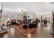 Spacious living room with hardwood floors, stone fireplace, and comfortable leather seating at 4538 Sterling Pointe Nw Dr, Kennesaw, GA 30152