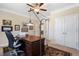 Office with a large desk and chair, a floral rug, neutral walls, and double doors at 4538 Sterling Pointe Nw Dr, Kennesaw, GA 30152