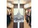 Well-lit walk-in closet with custom shelving and hanging rods plus Eiffel Tower art at 4538 Sterling Pointe Nw Dr, Kennesaw, GA 30152
