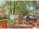 Backyard with a black grill and view of the lawn, shed, and trees at 1340 Hawthorne Se Ave, Smyrna, GA 30080