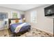 Bright bedroom featuring two windows, matching lamps, neutral walls, and a blue patterned rug at 1340 Hawthorne Se Ave, Smyrna, GA 30080
