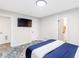 Bedroom featuring a TV hung on the wall, white trim, and a view into the bathroom at 1340 Hawthorne Se Ave, Smyrna, GA 30080