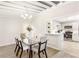 Bright dining area featuring a glass table, stylish chairs, modern chandelier, and an open view to a remodeled kitchen at 1340 Hawthorne Se Ave, Smyrna, GA 30080