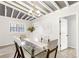 Dining room features a glass table, modern chandelier, and white walls with an open doorway to the home's interior at 1340 Hawthorne Se Ave, Smyrna, GA 30080