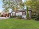 Beautifully landscaped front yard with a charming white brick home at 1340 Hawthorne Se Ave, Smyrna, GA 30080