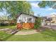 Quaint home featuring a wooden porch, painted brick, and landscaped yard with mature trees in a suburban setting at 1340 Hawthorne Se Ave, Smyrna, GA 30080