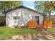 Charming single-story home with white brick, black trim, and a wooden porch, nestled in a lush, green yard at 1340 Hawthorne Se Ave, Smyrna, GA 30080