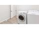 Laundry room area with washer and dryer and white walls with wood trim at 1340 Hawthorne Se Ave, Smyrna, GA 30080