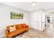 Sitting room with gray walls, a bright orange futon with throw pillows, and an open doorway to the modern kitchen at 1340 Hawthorne Se Ave, Smyrna, GA 30080
