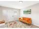 Sitting room with gray walls and a bright orange futon featuring a large window and decor at 1340 Hawthorne Se Ave, Smyrna, GA 30080