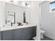 Bathroom features a double sink vanity with stylish fixtures and a view into the bedroom at 2424 Memorial Se Dr # 3, Atlanta, GA 30317