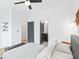Bright bedroom featuring a ceiling fan, a doorway to the bathroom, and comfortable furnishings at 2424 Memorial Se Dr # 3, Atlanta, GA 30317